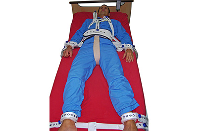 Devices for restraining and securing patients in bed